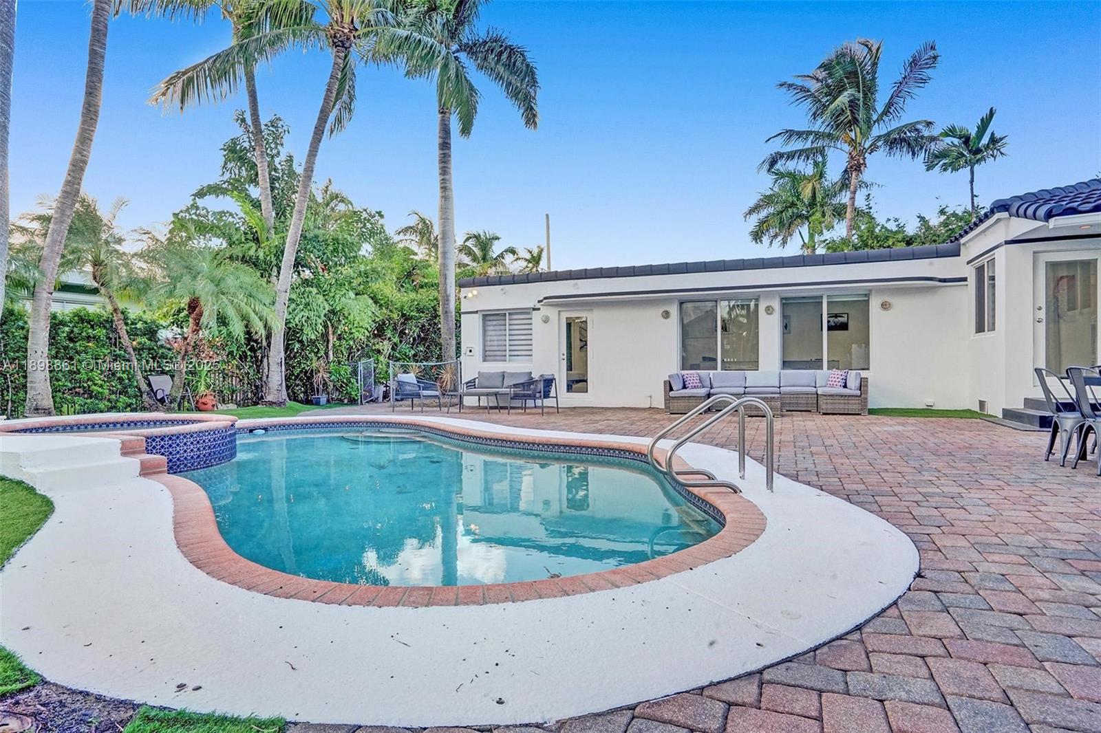 725 Harrison Street Hollywood, FL 33019 - Photo 74 of 91 a view of a swimming pool with a yard