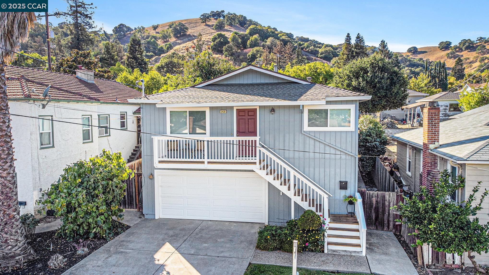 a front view of a house with a yard and trees