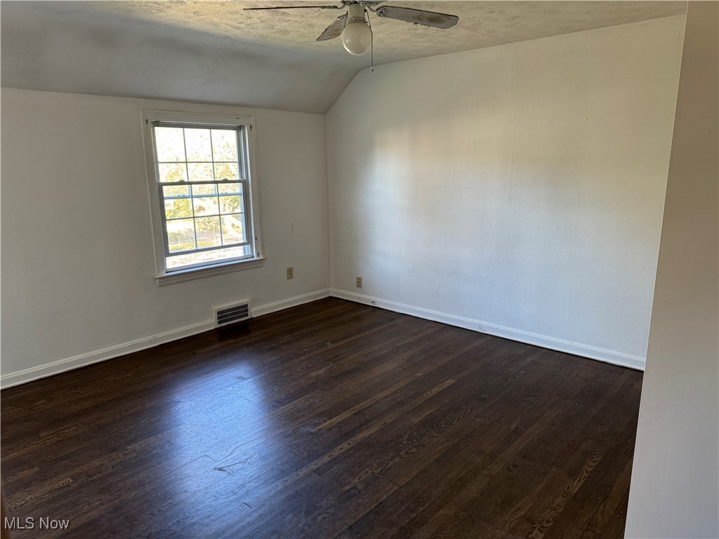 3958 Bushnell Road Cleveland, OH 44118 - Photo 7 of 10 dark wood floors, vaulted ceiling, and a ceiling fan