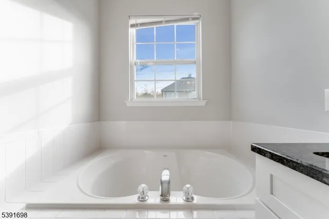 a bath tub sitting in a bathroom next to a window