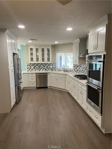 a kitchen with a sink stove and refrigerator