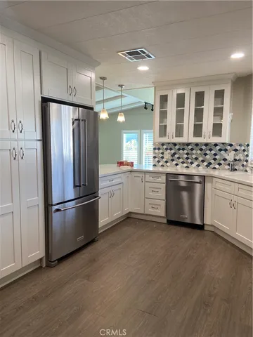 a kitchen with stainless steel appliances a refrigerator sink and cabinets