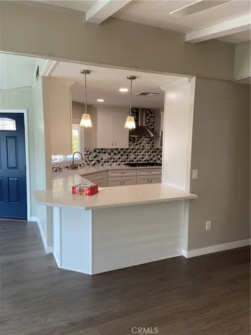 a view hallway with wooden floor and staircase