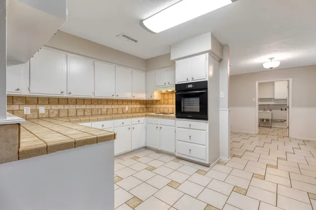 a kitchen with cabinets and appliances