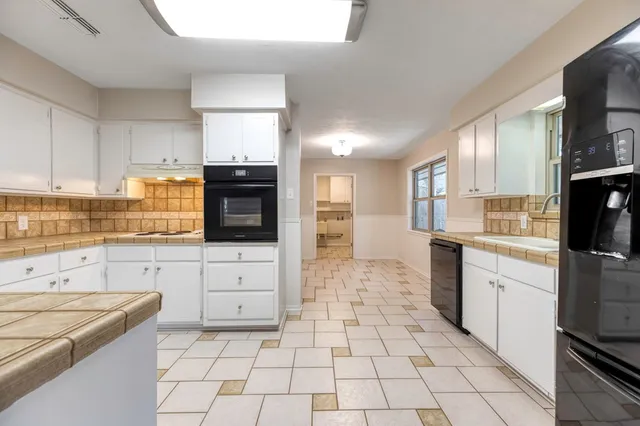 a kitchen with a stove a sink and a refrigerator