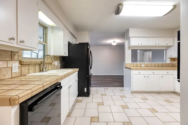a kitchen with a stove a refrigerator and a sink