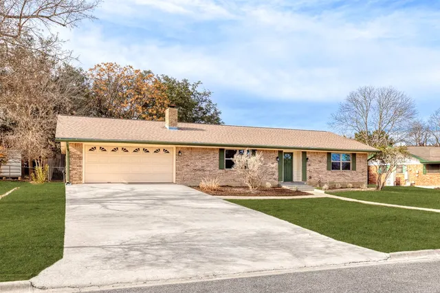 a front view of house with yard and green space