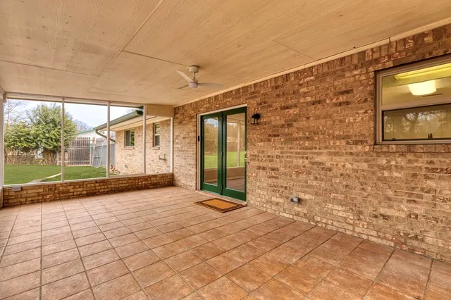 a view of a brick house with a wooden bench in front of it