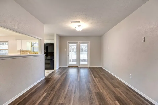 a view of a kitchen with wooden floor and a kitchen