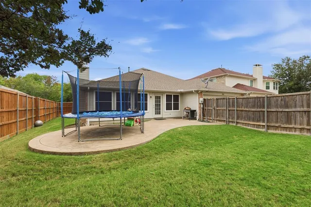a view of a house with a swimming pool and a yard