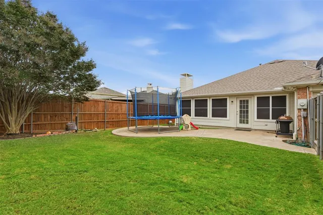 a view of a house with a yard and a garden