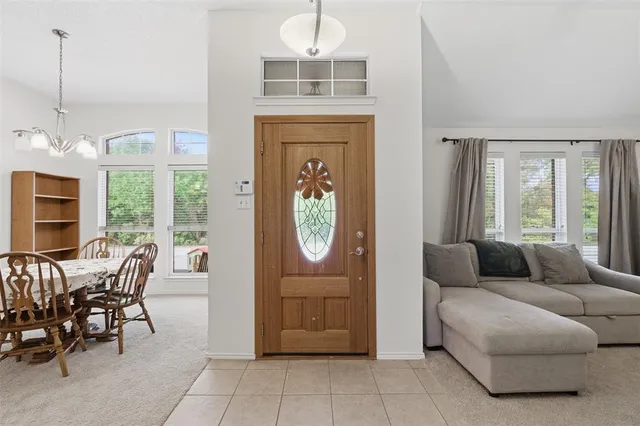 a living room with furniture a window and a chandelier