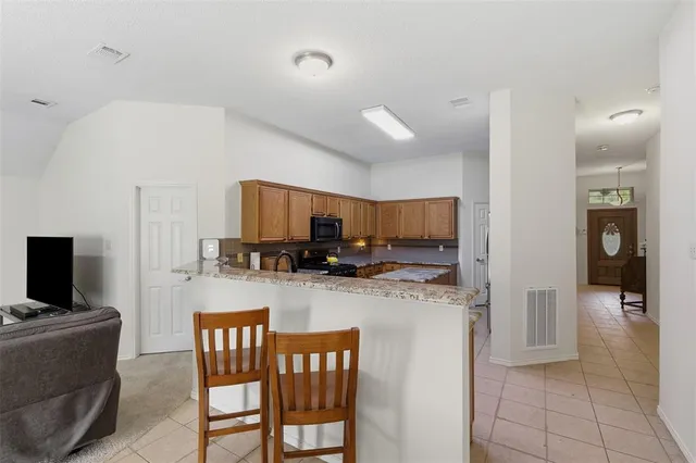 a kitchen with sink a counter top space appliances and cabinets