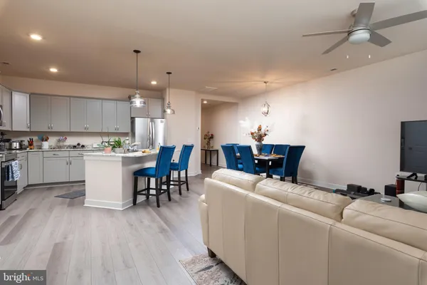 a living room with furniture and kitchen view