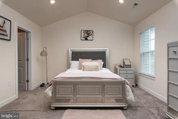 a bedroom with a bed and window