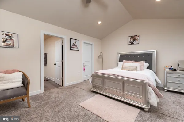 a bedroom with a bed and a chair