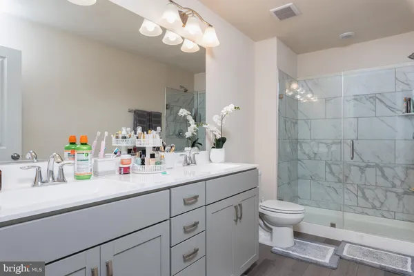 a bathroom with a sink a toilet and shower