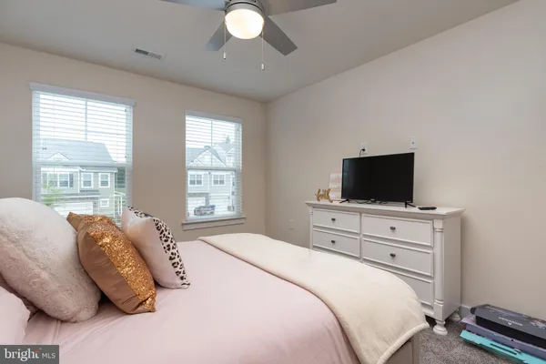 a bedroom with a bed and flat screen tv