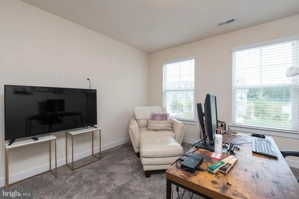 a bathroom with a sink a toilet a mirror and shower curtain