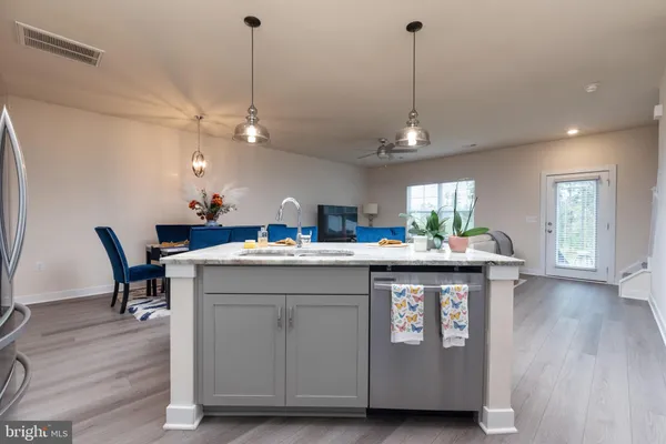 a kitchen with a sink cabinetry and wooden floor