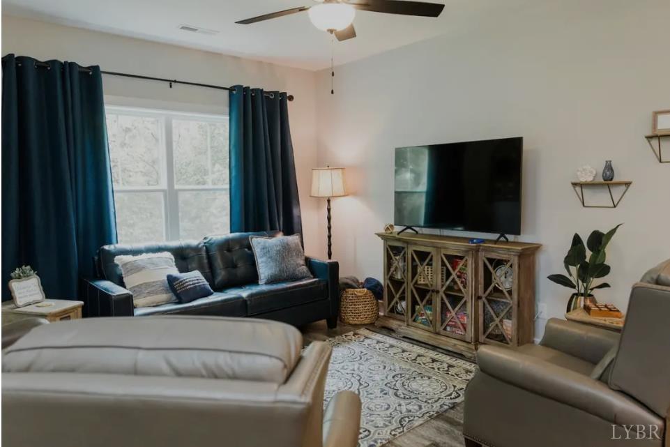 1300 Stoney Ridge Boulevard, Unit 101 Forest, VA 24551 - Photo 4 of 18 a living room with furniture and a flat screen tv