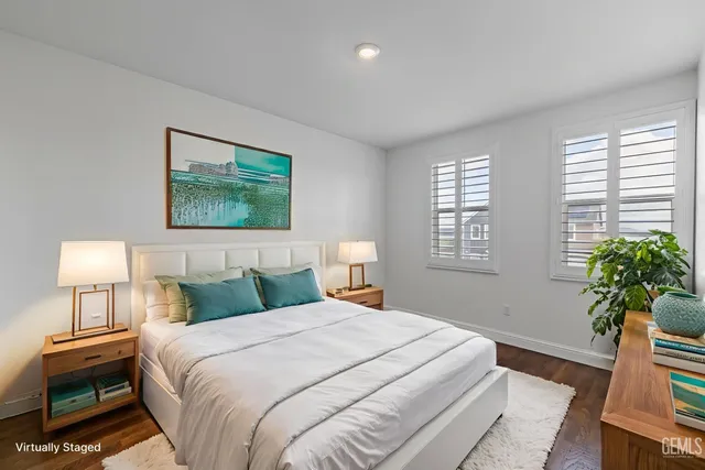 a bedroom with a bed and a potted plant