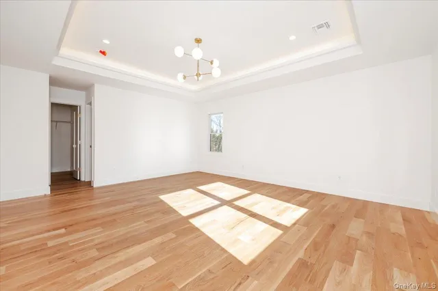 a large kitchen with kitchen island white cabinets and wooden floor
