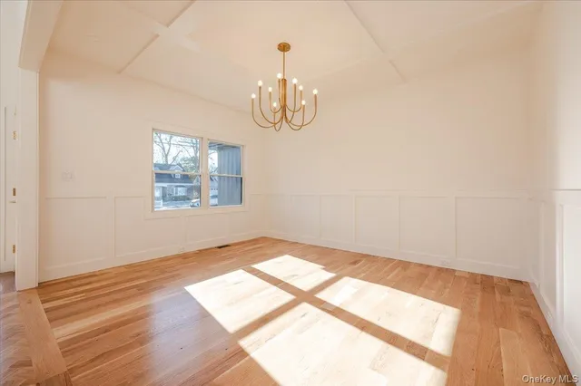 a view of a dining room with furniture wooden floor and chandelier