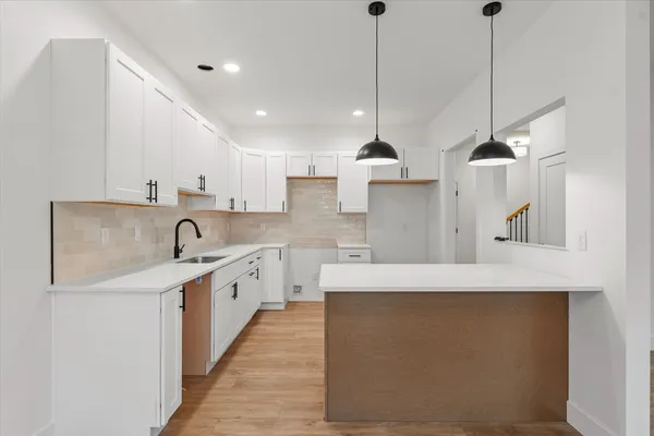 a large kitchen with stainless steel appliances kitchen island a large island in it