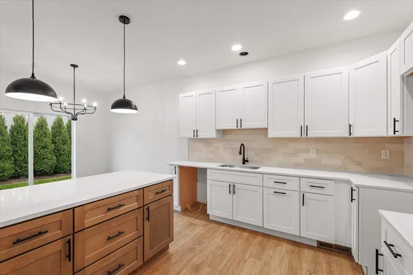 a kitchen with a sink window and cabinets