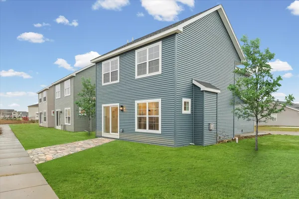 a view of a house with a backyard