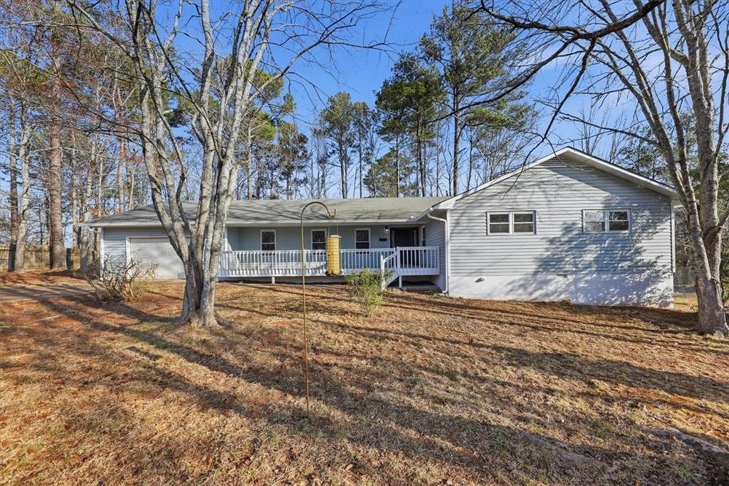 8976 Ochil Lane Winston, GA 30187 - Photo 1 of 53 a front view of a house with garden
