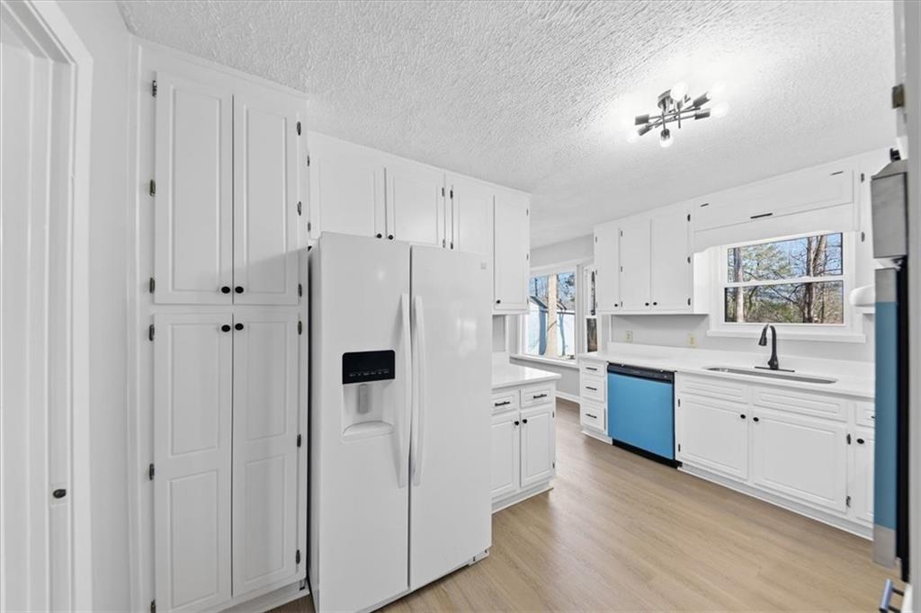 8976 Ochil Lane Winston, GA 30187 - Photo 13 of 53 a large white kitchen with stainless steel appliances a white cabinet