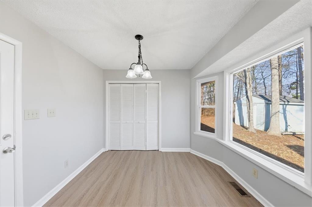 8976 Ochil Lane Winston, GA 30187 - Photo 17 of 53 a view of empty room with wooden floor and fan
