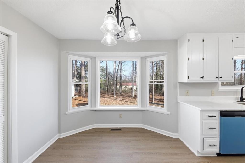 8976 Ochil Lane Winston, GA 30187 - Photo 18 of 53 a view of an empty room with a window and wooden floor