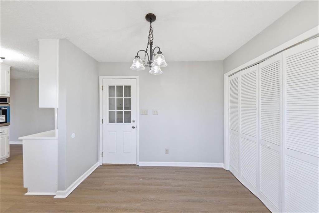 8976 Ochil Lane Winston, GA 30187 - Photo 19 of 53 wooden floor in an empty room with a window