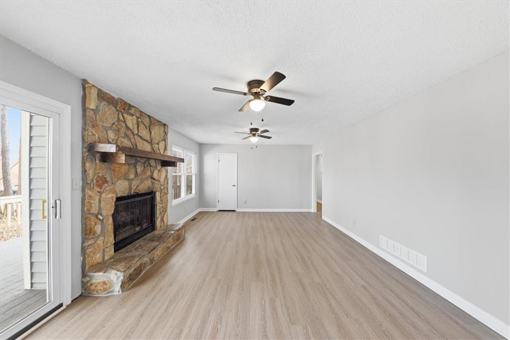 8976 Ochil Lane Winston, GA 30187 - Photo 20 of 53 wooden floor in an empty room with a fireplace