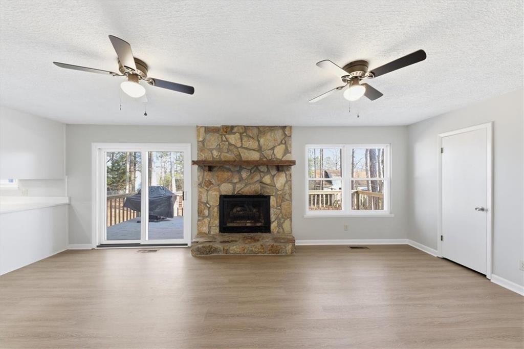 8976 Ochil Lane Winston, GA 30187 - Photo 21 of 53 a view of an empty room with a window and fireplace