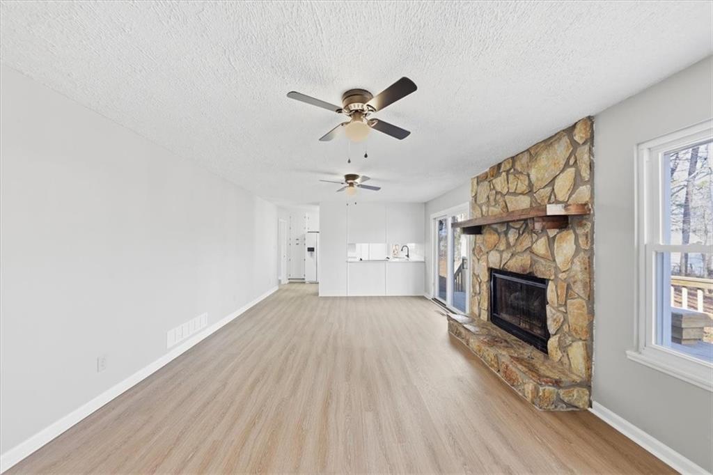 8976 Ochil Lane Winston, GA 30187 - Photo 22 of 53 an empty room with fireplace fan and windows