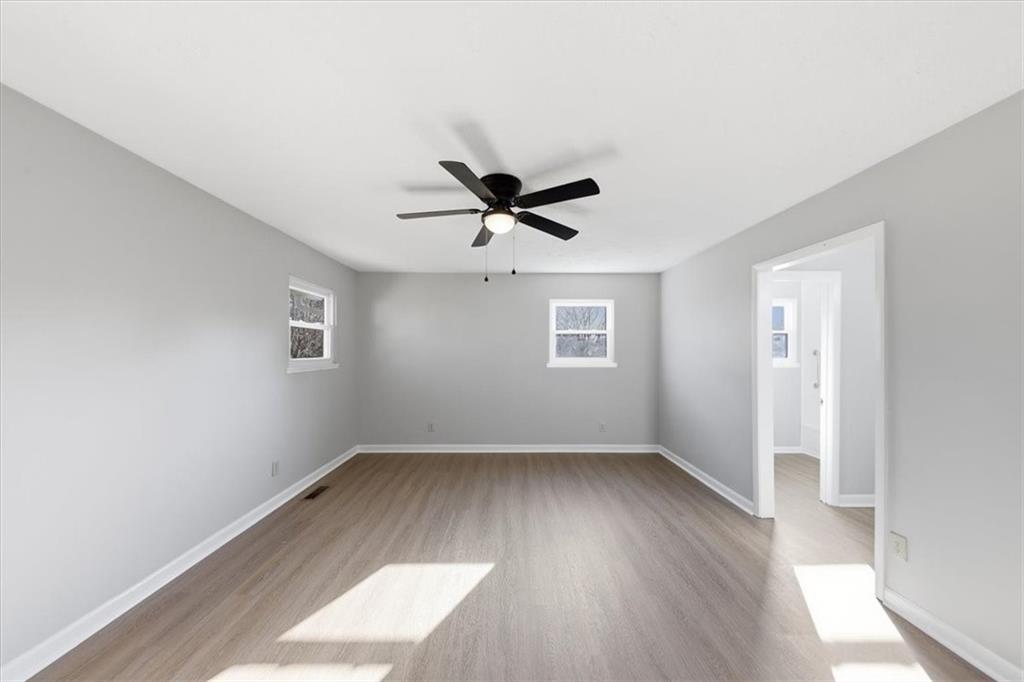 8976 Ochil Lane Winston, GA 30187 - Photo 23 of 53 an empty room with wooden floor and ceiling fan