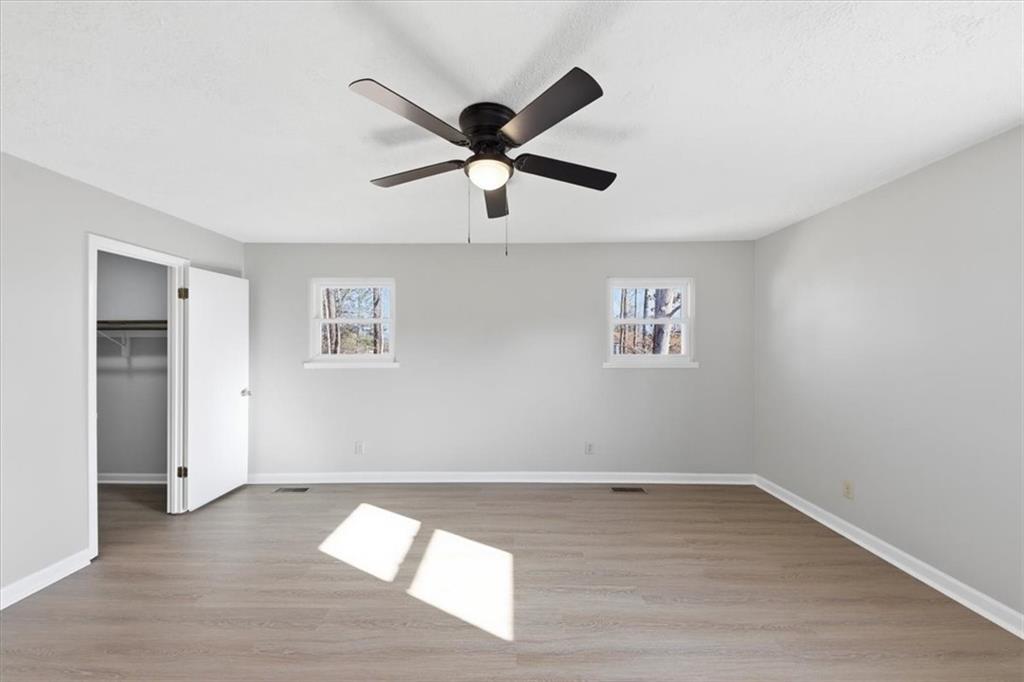 8976 Ochil Lane Winston, GA 30187 - Photo 24 of 53 wooden floor in an empty room with a window
