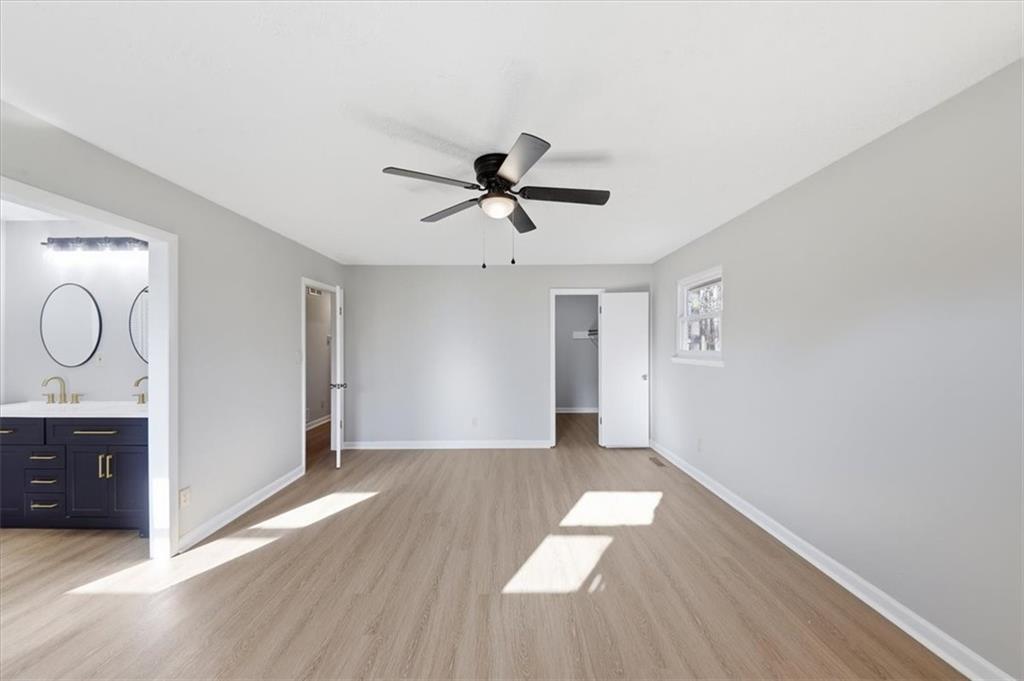 8976 Ochil Lane Winston, GA 30187 - Photo 25 of 53 a view of empty room with wooden floor and fan
