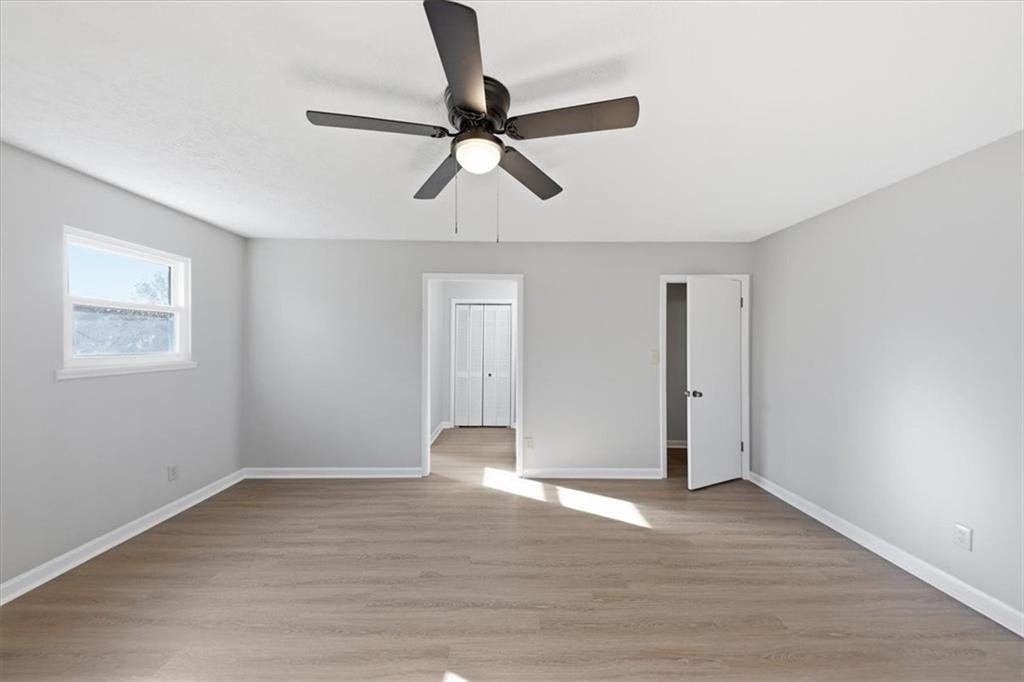 8976 Ochil Lane Winston, GA 30187 - Photo 26 of 53 a view of empty room with wooden floor and window