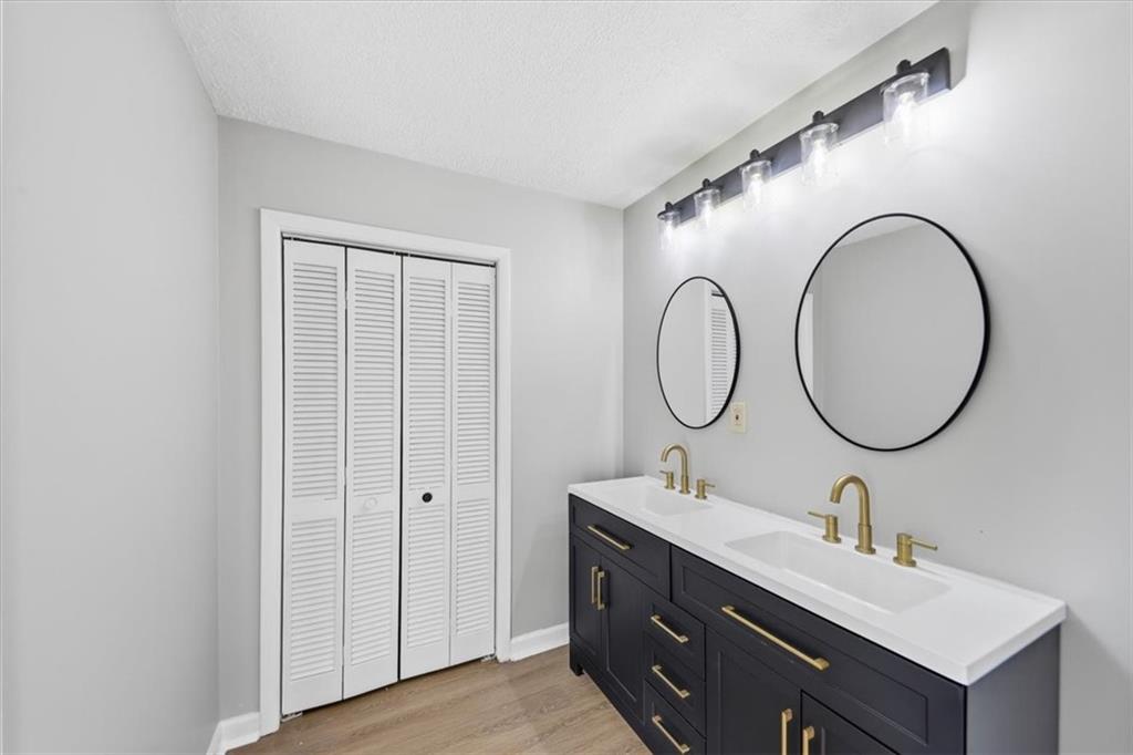 8976 Ochil Lane Winston, GA 30187 - Photo 27 of 53 a bathroom with a double vanity sink and a mirror