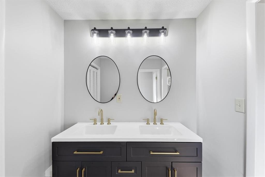 8976 Ochil Lane Winston, GA 30187 - Photo 28 of 53 a bathroom with a sink and a mirror