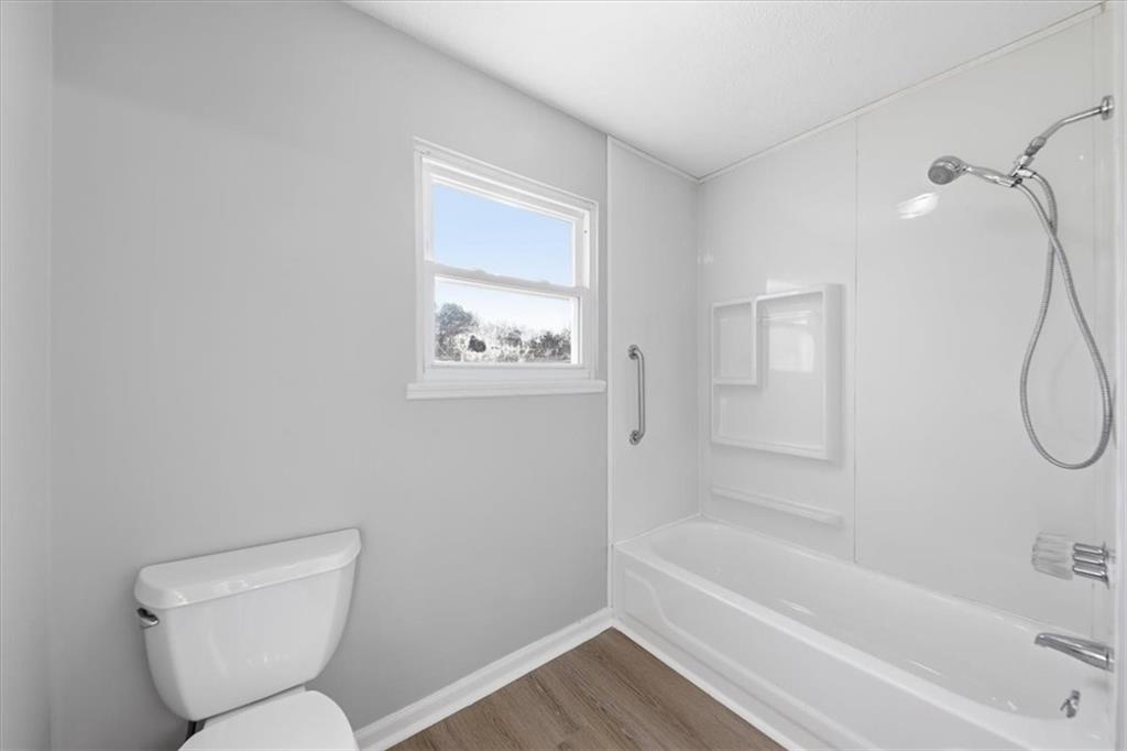 8976 Ochil Lane Winston, GA 30187 - Photo 29 of 53 a bathroom with a toilet and a shower