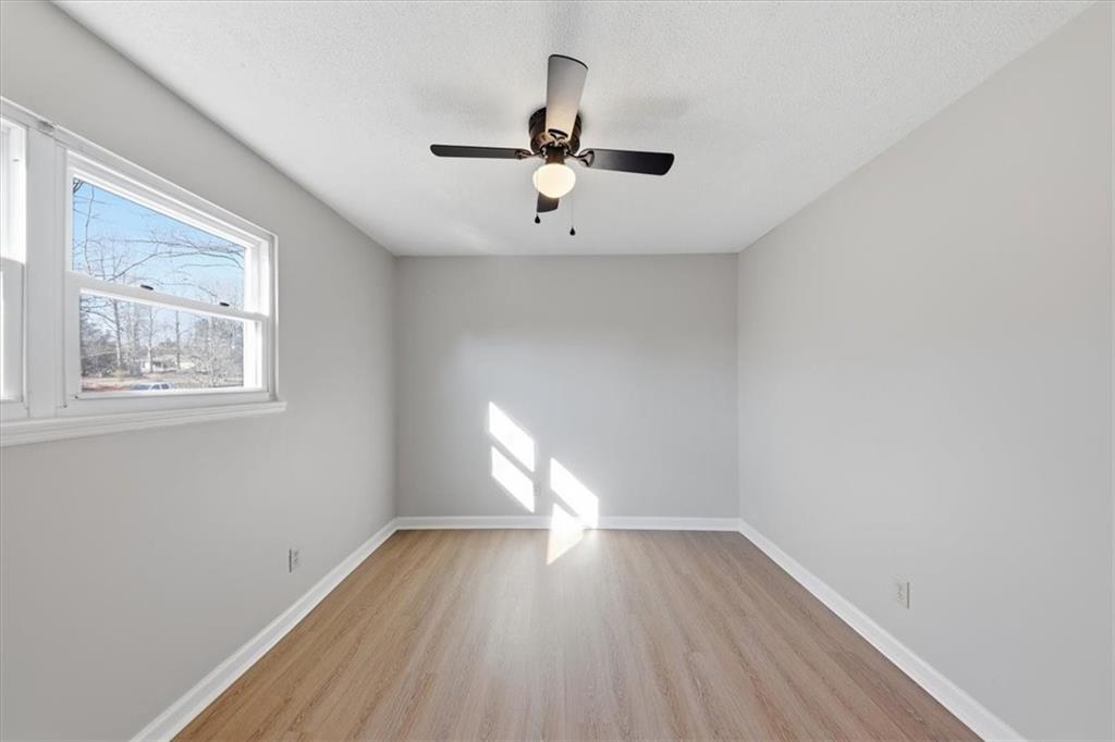 8976 Ochil Lane Winston, GA 30187 - Photo 34 of 53 a view of empty room with wooden floor fan and window