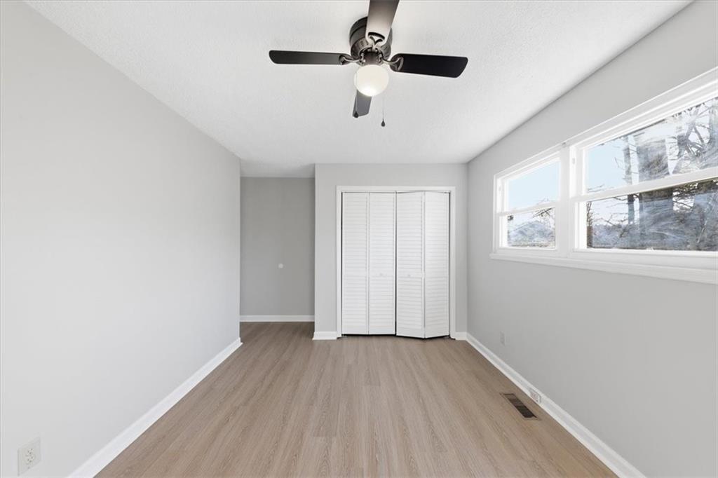 8976 Ochil Lane Winston, GA 30187 - Photo 35 of 53 a view of an empty room with wooden floor and a window