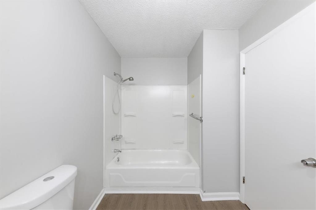 8976 Ochil Lane Winston, GA 30187 - Photo 37 of 53 a bathroom with a bathtub and a toilet