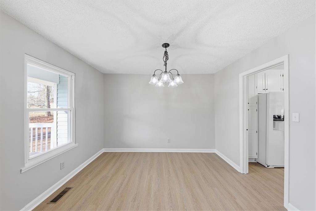 8976 Ochil Lane Winston, GA 30187 - Photo 10 of 53 wooden floor in an empty room with a window